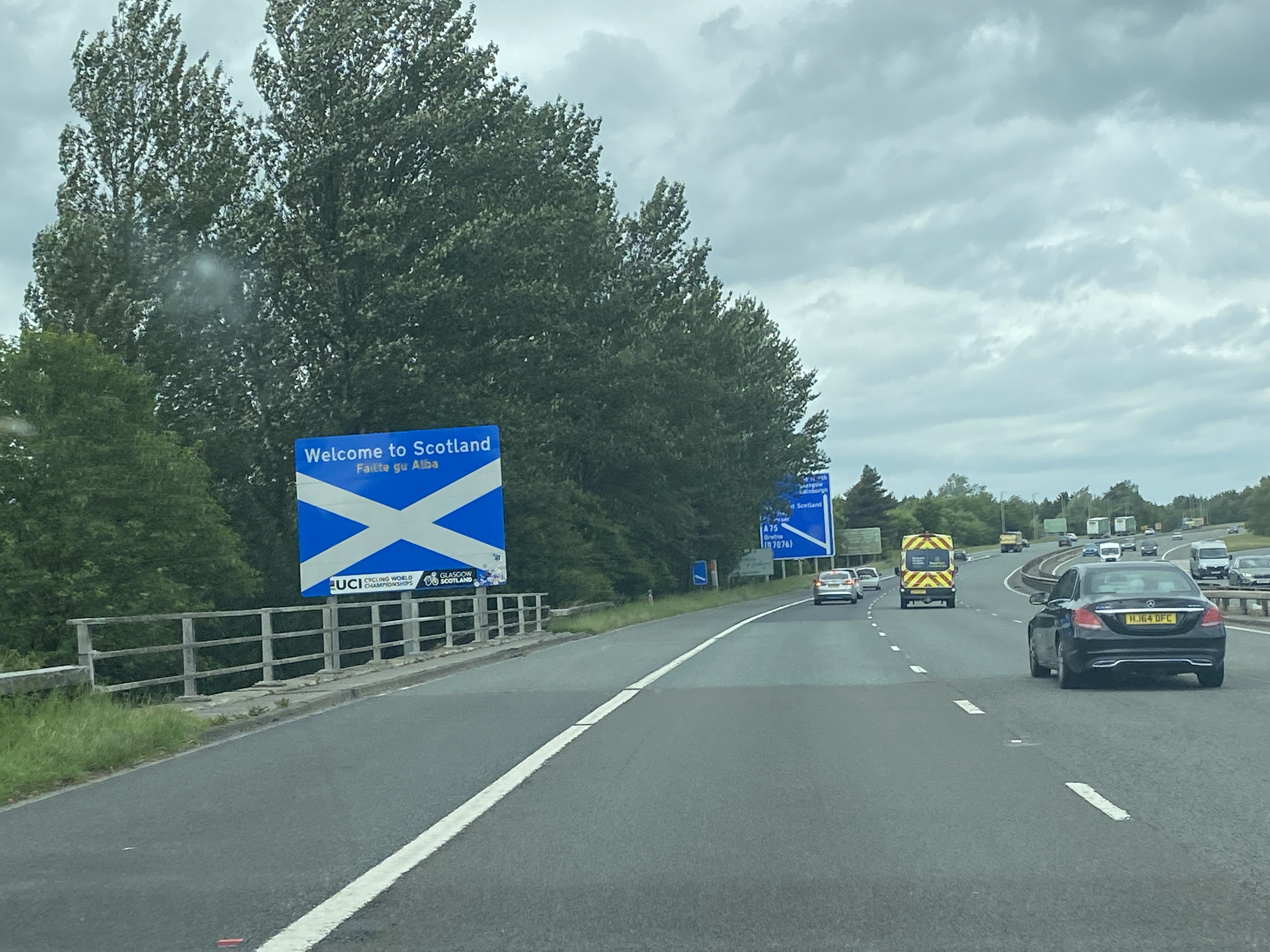 M74 motorway sign for Scotland with Saltire Flag
